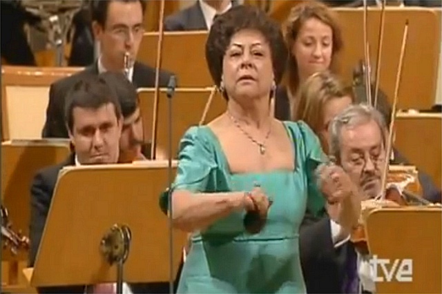The orchestra plays a classical piece, but when she joins them, all becomes like magic
