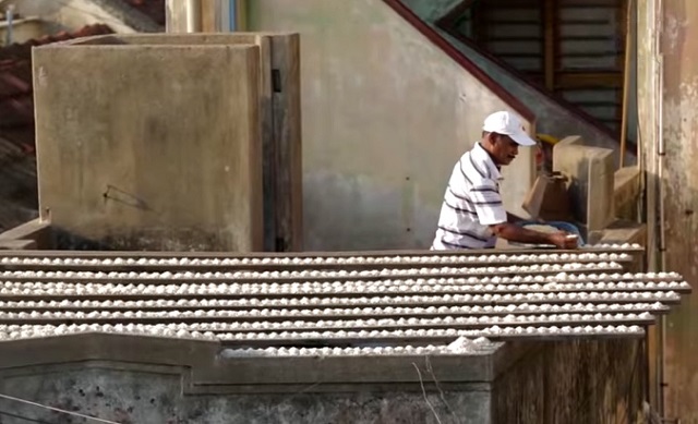 He aligns piles of rice on his roof – you won’t believe why