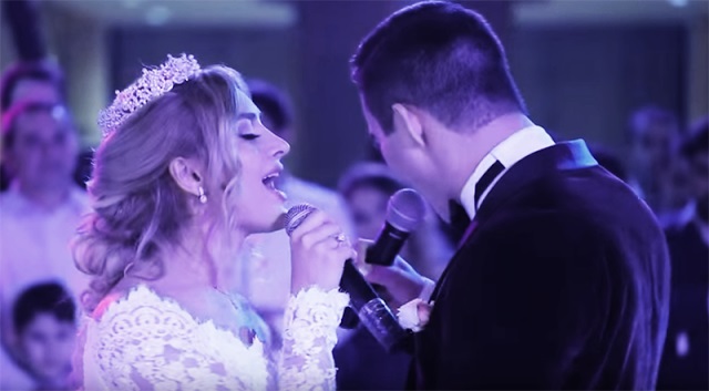 The bride and groom sing a love song in a beautiful duet