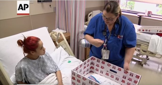 The nurse places the newborn in a cardboard box. This may seem strange, but the reason behind it is brilliant